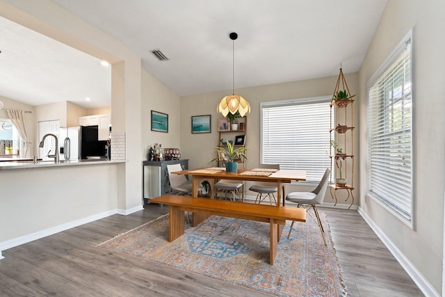 6351 Adams St, Jupiter, FL 33458 - dining space with wood finished floors and vaulted ceiling
