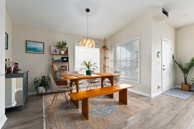 6351 Adams St, Jupiter, FL 33458 - dining space with light wood-type flooring and vaulted ceiling