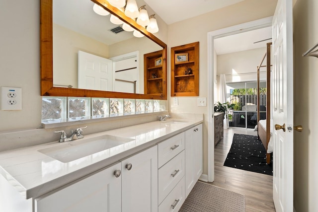 6351 Adams St, Jupiter, FL 33458 - full bathroom with double vanity and wood finished floors
