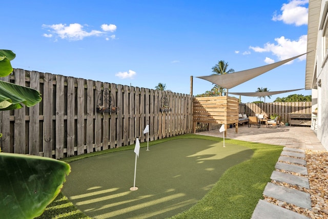 6351 Adams St, Jupiter, FL 33458 - fenced backyard with an area to practice putting and a patio area