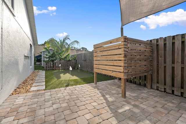 6351 Adams St, Jupiter, FL 33458 - fenced backyard with an area to practice putting and a patio area