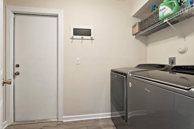 6351 Adams St, Jupiter, FL 33458 - laundry area with washer and clothes dryer and wood finished floors