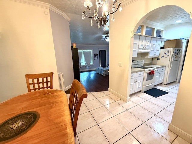 1114 SW Del Rio Blvd, Port Saint Lucie, FL 34953 - dining room featuring ornamental molding, arched walkways, ceiling fan, light tile patterned floors, and a chandelier