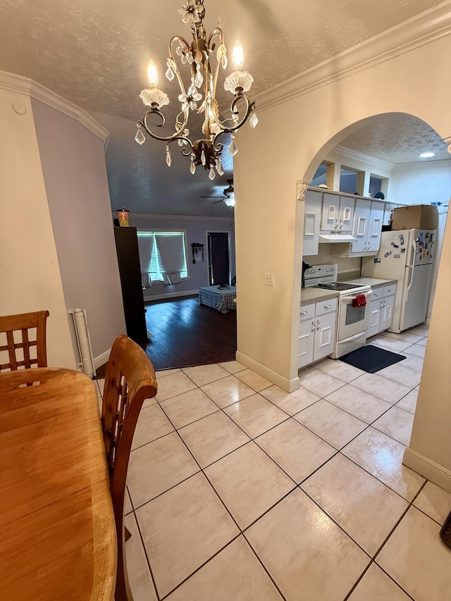 1114 SW Del Rio Blvd, Port Saint Lucie, FL 34953 - dining room with light tile patterned floors, arched walkways, crown molding, a textured ceiling, and a chandelier