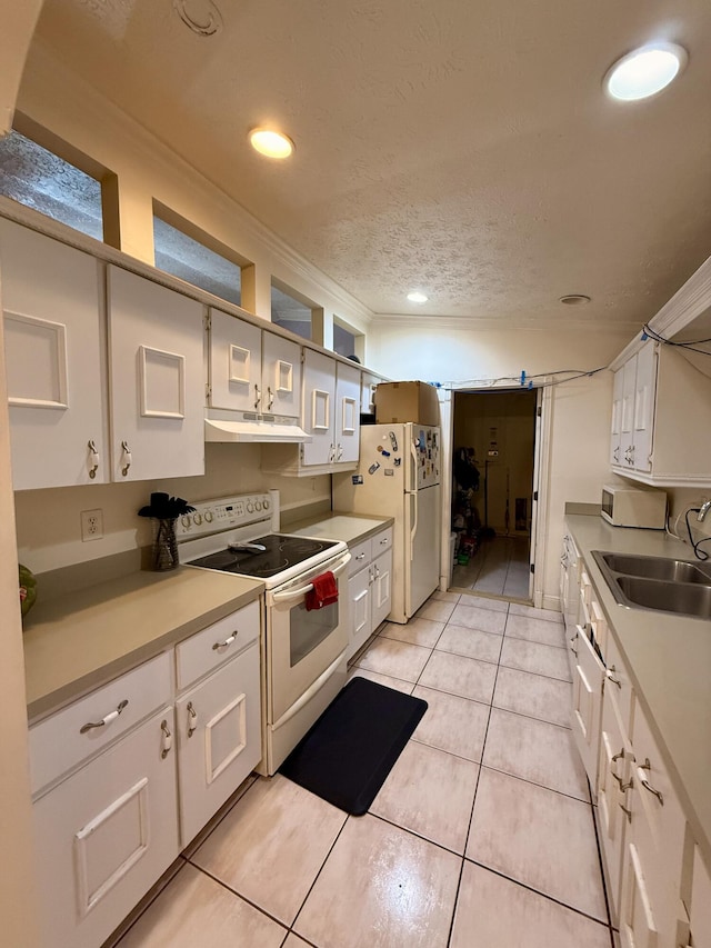 1114 SW Del Rio Blvd, Port Saint Lucie, FL 34953 - kitchen featuring white appliances, under cabinet range hood, white cabinets, light tile patterned floors, and a textured ceiling