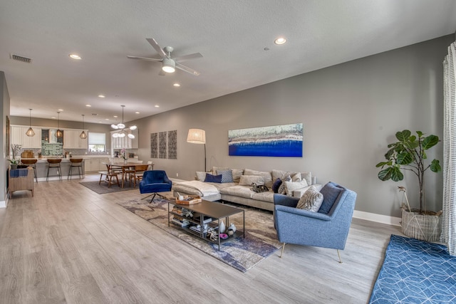 5178 Beckman Ter, Palm Beach Gardens, FL 33418 - living area with light wood finished floors, recessed lighting, a ceiling fan, and a chandelier