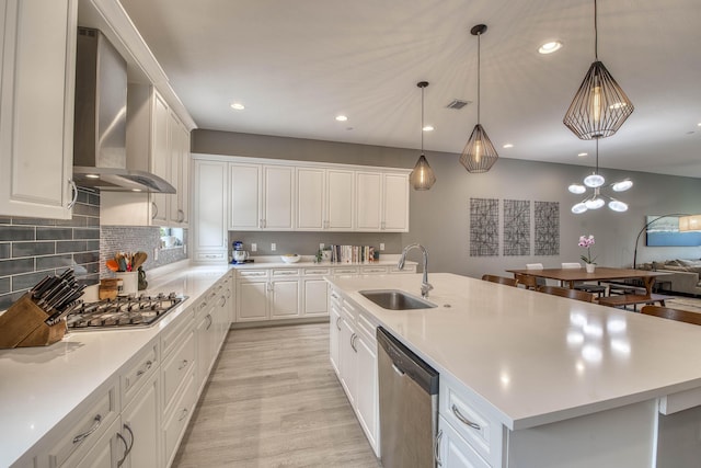 5178 Beckman Ter, Palm Beach Gardens, FL 33418 - kitchen with stainless steel appliances, wall chimney range hood, light wood-type flooring, light countertops, and white cabinets