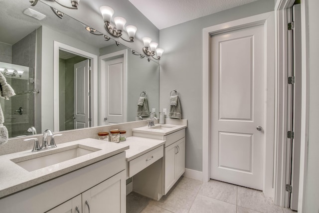 5178 Beckman Ter, Palm Beach Gardens, FL 33418 - bathroom with double vanity, a stall shower, tile patterned floors, and a textured ceiling