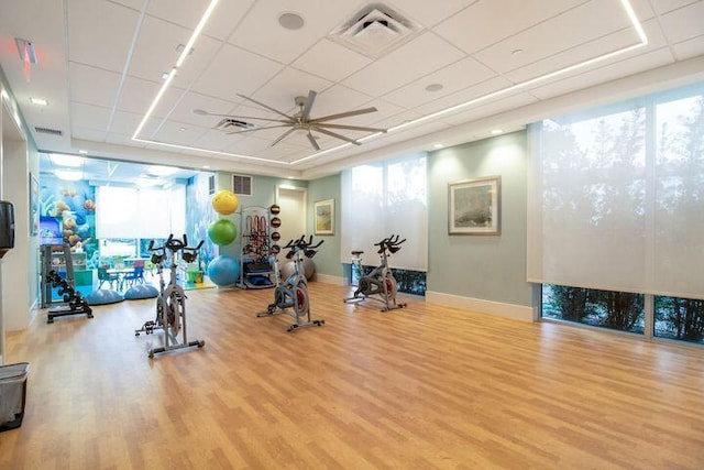 5178 Beckman Ter, Palm Beach Gardens, FL 33418 - workout area with wood finished floors, plenty of natural light, a ceiling fan, floor to ceiling windows, and a drop ceiling