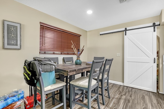 1395 SE Darling St, Stuart, FL 34997 - dining area featuring a barn door, wood finished floors, and recessed lighting