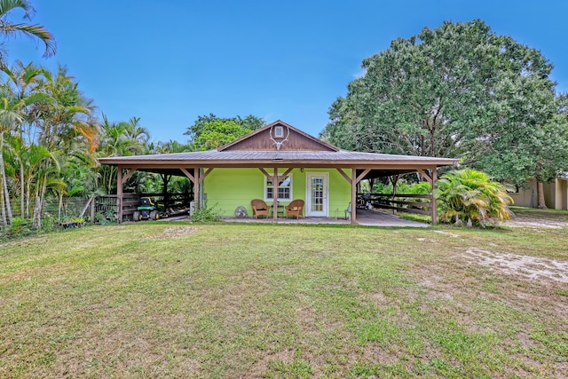 1395 SE Darling St, Stuart, FL 34997 - view of front of property with an attached carport, a metal roof, and french doors