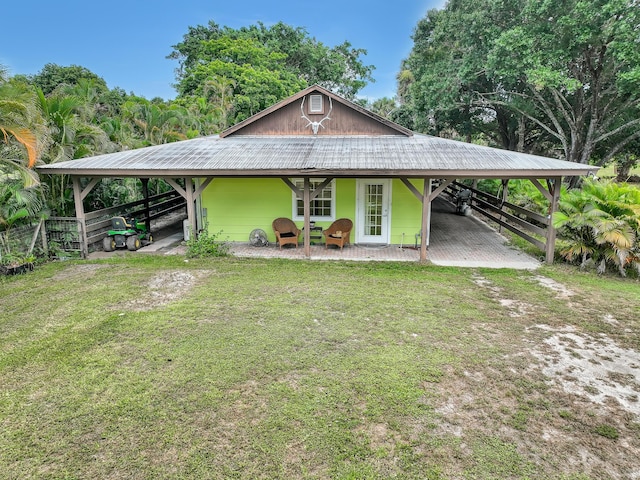 1395 SE Darling St, Stuart, FL 34997 - country-style home featuring an attached carport, a metal roof, and an exterior structure