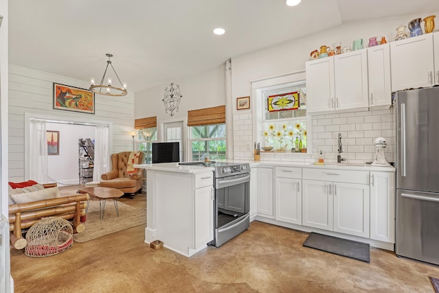 1395 SE Darling St, Stuart, FL 34997 - kitchen featuring stainless steel appliances, concrete floors, light countertops, a peninsula, and open floor plan