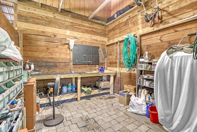 1395 SE Darling St, Stuart, FL 34997 - misc room featuring a workshop area, wooden walls, and brick patterned flooring