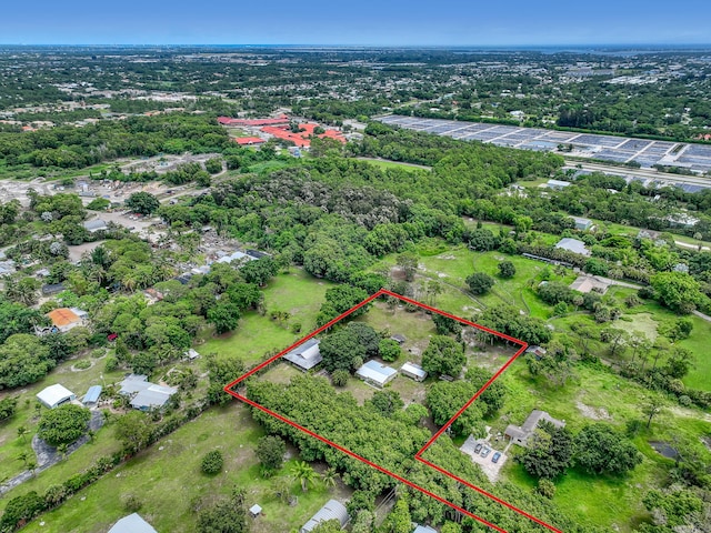 1395 SE Darling St, Stuart, FL 34997 - aerial overview of property's location with property parcel outlined and a tree filled landscape
