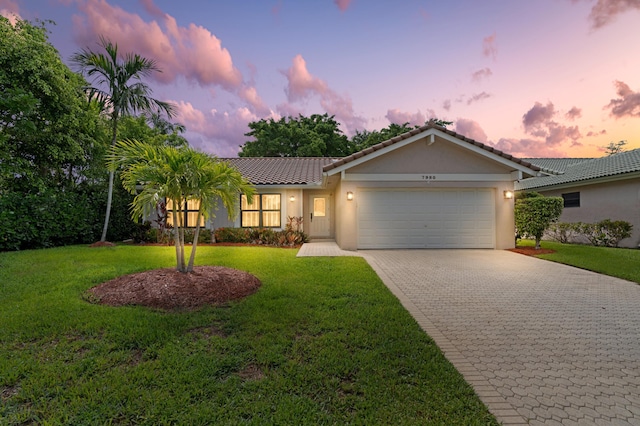 7980 Cloverfield Cir, Boca Raton, FL 33433 - ranch-style house featuring a garage, decorative driveway, a tiled roof, stucco siding, and a front lawn