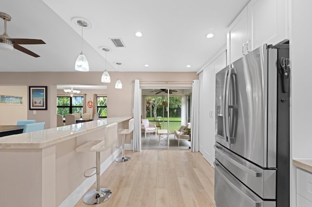 7980 Cloverfield Cir, Boca Raton, FL 33433 - kitchen with stainless steel refrigerator with ice dispenser, a ceiling fan, white cabinets, light wood finished floors, and recessed lighting