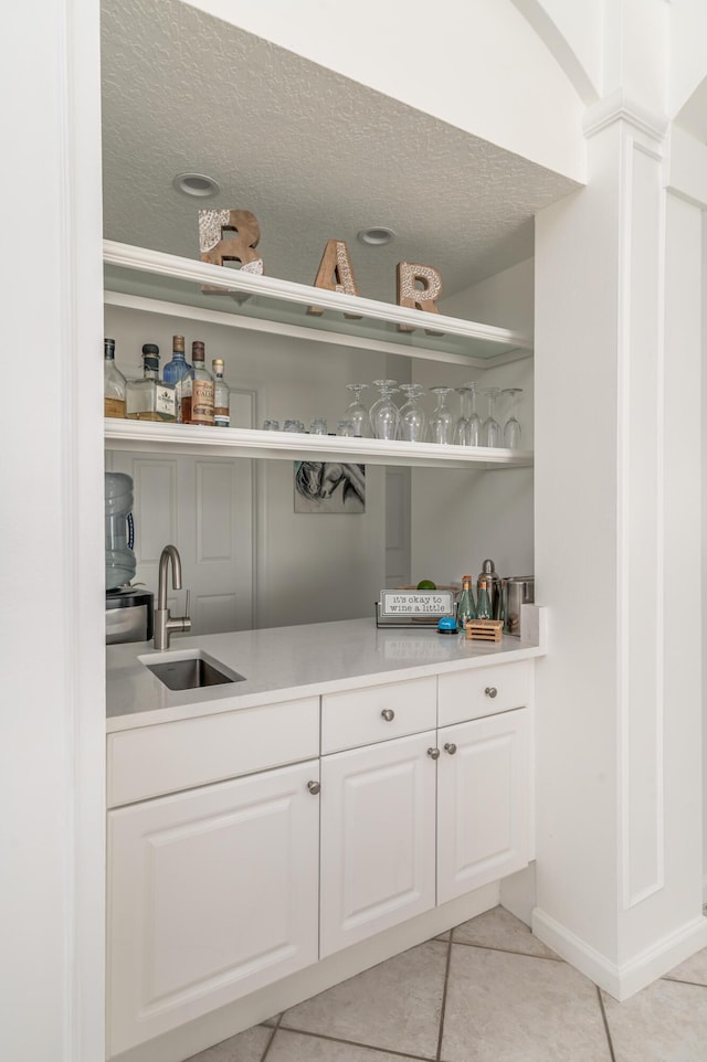1513 SE Holyrood Ln, Port Saint Lucie, FL 34952 - bar area featuring light tile patterned floors and a textured ceiling