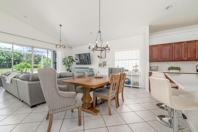 1513 SE Holyrood Ln, Port Saint Lucie, FL 34952 - dining area featuring vaulted ceiling, light tile patterned floors, and a chandelier