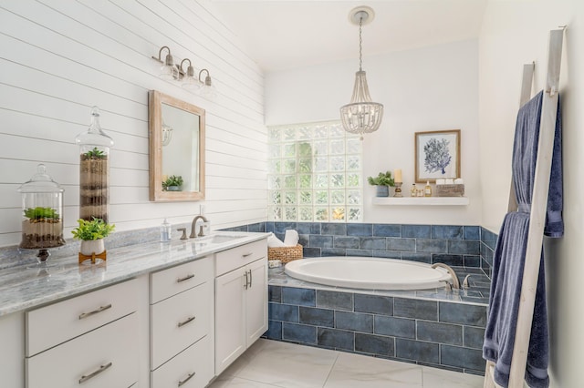 1513 SE Holyrood Ln, Port Saint Lucie, FL 34952 - full bathroom featuring vanity, a garden tub, a chandelier, and tile patterned flooring