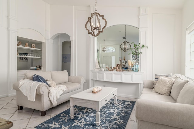 1513 SE Holyrood Ln, Port Saint Lucie, FL 34952 - living room with arched walkways, light tile patterned floors, and a chandelier