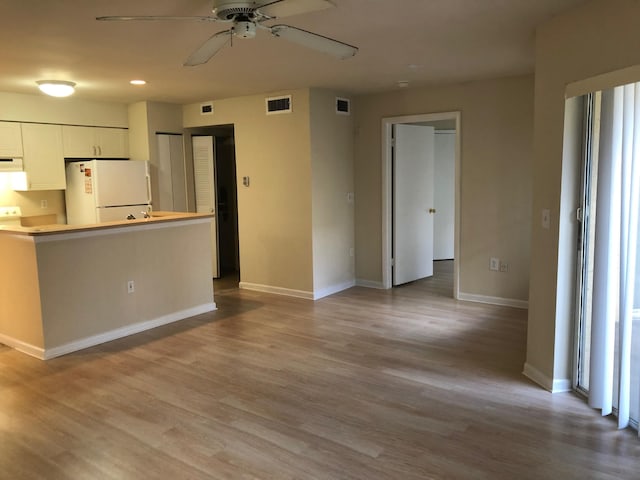 4855 Via Palm Lks Unit 904, West Palm Beach, FL 33417 - kitchen with freestanding refrigerator, ceiling fan, white cabinets, wood finished floors, and recessed lighting