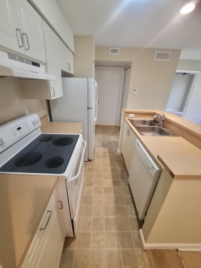 4855 Via Palm Lks Unit 904, West Palm Beach, FL 33417 - kitchen with white appliances, under cabinet range hood, white cabinetry, and light countertops