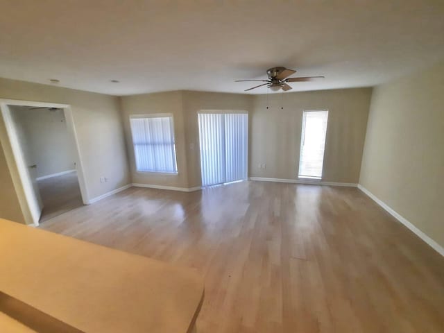 4855 Via Palm Lks Unit 904, West Palm Beach, FL 33417 - unfurnished living room with light wood finished floors and ceiling fan