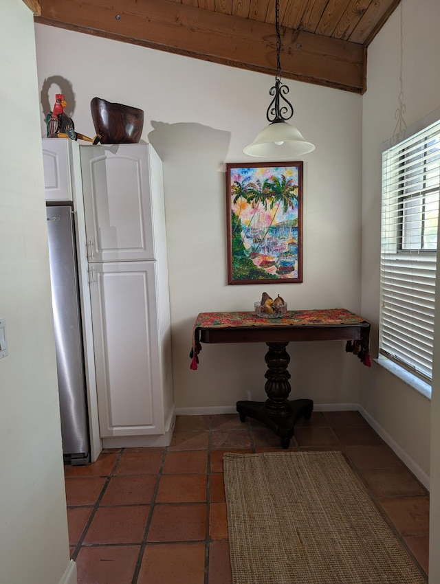 2904 N 35th Ter, Hollywood, FL 33021 - dining area featuring light tile patterned flooring, a wood ceiling with exposed beams, and plenty of natural light