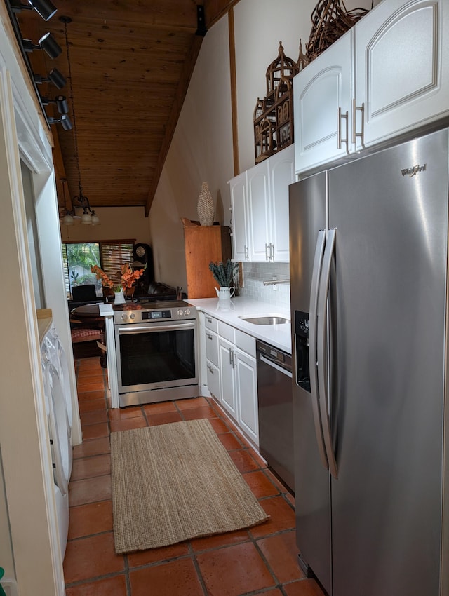 2904 N 35th Ter, Hollywood, FL 33021 - kitchen with appliances with stainless steel finishes, wood ceiling, vaulted ceiling, white cabinets, and decorative backsplash