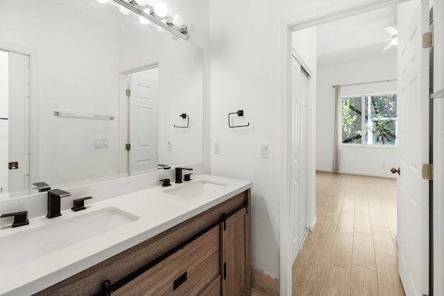 5711 NW 125th Ave, Coral Springs, FL 33076 - bathroom featuring double vanity and wood finished floors