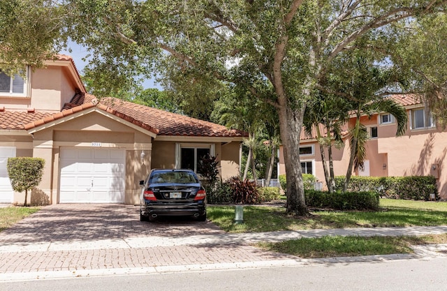 5711 NW 125th Ave, Coral Springs, FL 33076 - view of front of home featuring decorative driveway, stucco siding, and a tiled roof