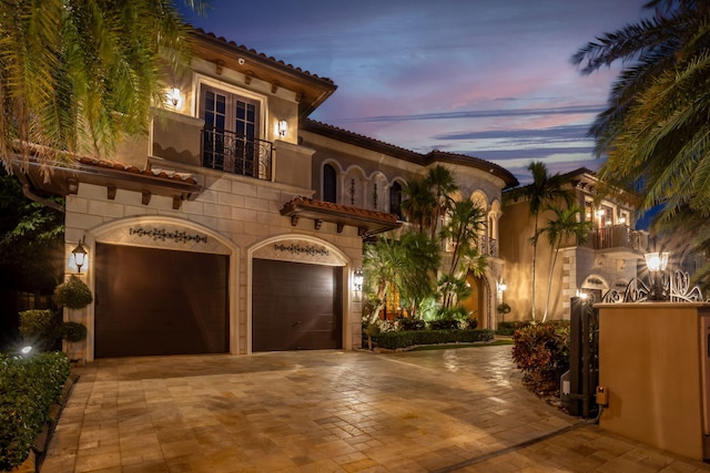 3870 NE 31st Ave, Lighthouse Point, FL 33064 - mediterranean / spanish house featuring a balcony, french doors, decorative driveway, a garage, and a tiled roof