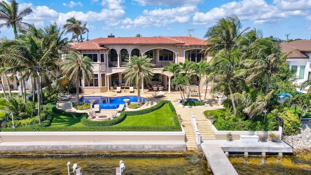 3870 NE 31st Ave, Lighthouse Point, FL 33064 - back of property with a balcony, a tile roof, a patio, an outdoor pool, and a chimney