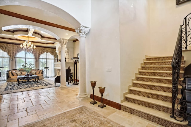3870 NE 31st Ave, Lighthouse Point, FL 33064 - stairs with decorative columns, stone tile floors, arched walkways, a chandelier, and a towering ceiling