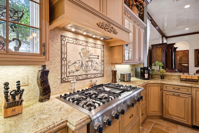 3870 NE 31st Ave, Lighthouse Point, FL 33064 - kitchen with stainless steel gas cooktop, custom exhaust hood, tasteful backsplash, glass insert cabinets, and light stone counters