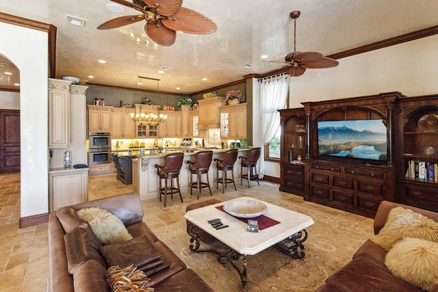 3870 NE 31st Ave, Lighthouse Point, FL 33064 - living room featuring a ceiling fan, stone tile flooring, ornamental molding, recessed lighting, and a chandelier