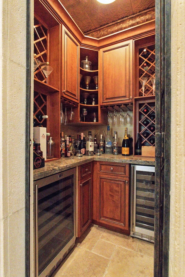 3870 NE 31st Ave, Lighthouse Point, FL 33064 - indoor dry bar featuring wine cooler, light stone finish flooring, ornamental molding, and tasteful backsplash