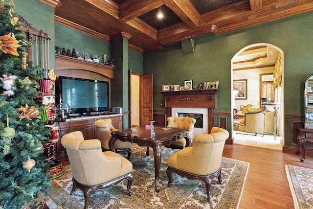 3870 NE 31st Ave, Lighthouse Point, FL 33064 - living area with arched walkways, beamed ceiling, coffered ceiling, wood-type flooring, and a glass covered fireplace