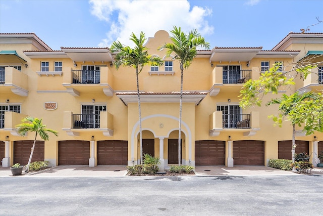 2536 SW 14th Ave Unit 1102, Fort Lauderdale, FL 33315 - view of front of property featuring an attached garage, stucco siding, and a tiled roof