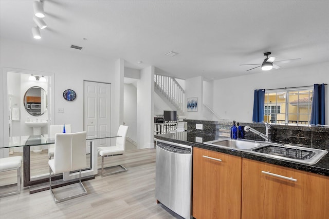 2536 SW 14th Ave Unit 1102, Fort Lauderdale, FL 33315 - kitchen with dishwasher, light wood-type flooring, a ceiling fan, brown cabinetry, and dark stone counters