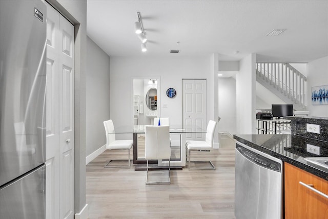 2536 SW 14th Ave Unit 1102, Fort Lauderdale, FL 33315 - kitchen with appliances with stainless steel finishes, light wood-style floors, and brown cabinets
