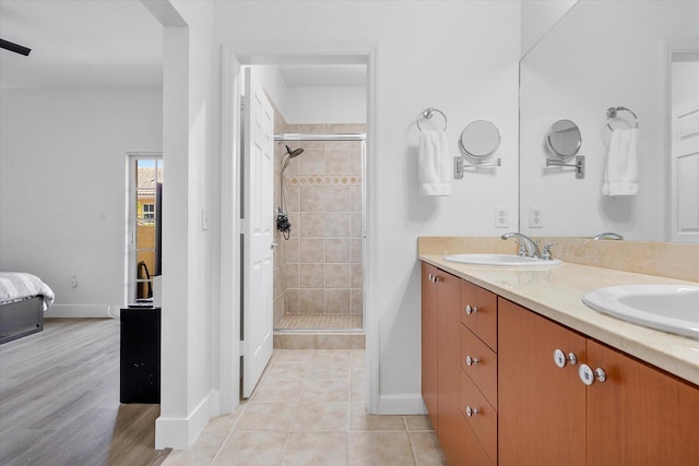 2536 SW 14th Ave Unit 1102, Fort Lauderdale, FL 33315 - ensuite bathroom with a stall shower, double vanity, and tile patterned flooring