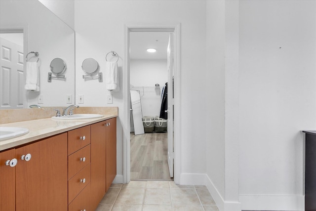 2536 SW 14th Ave Unit 1102, Fort Lauderdale, FL 33315 - bathroom featuring double vanity, a spacious closet, and tile patterned flooring
