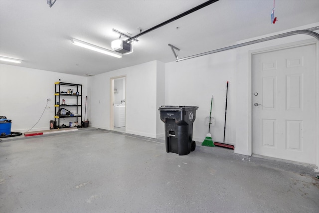 2536 SW 14th Ave Unit 1102, Fort Lauderdale, FL 33315 - garage featuring a garage door opener and washer / dryer