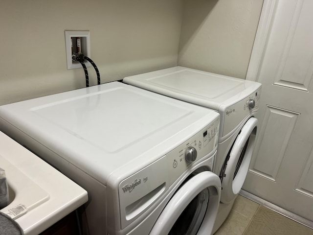 3303 E Mallory Blvd, Jupiter, FL 33458 - laundry room with washing machine and dryer and light tile patterned flooring