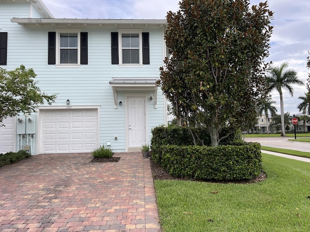 3303 E Mallory Blvd, Jupiter, FL 33458 - traditional-style home featuring decorative driveway and an attached garage