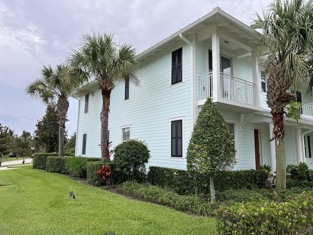 3303 E Mallory Blvd, Jupiter, FL 33458 - view of property exterior with a balcony and a lawn