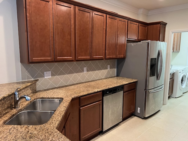 3303 E Mallory Blvd, Jupiter, FL 33458 - kitchen featuring stainless steel appliances, independent washer and dryer, light stone counters, ornamental molding, and decorative backsplash