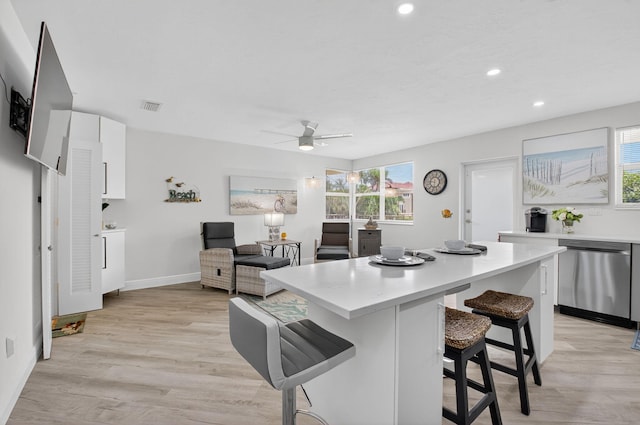 930 Osceola Dr Unit 8, Boca Raton, FL 33432 - kitchen featuring stainless steel dishwasher, a kitchen breakfast bar, white cabinets, light countertops, and a center island